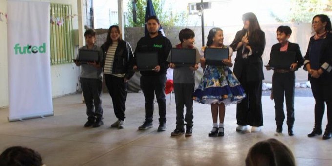 Students receiving donated laptops through Futed