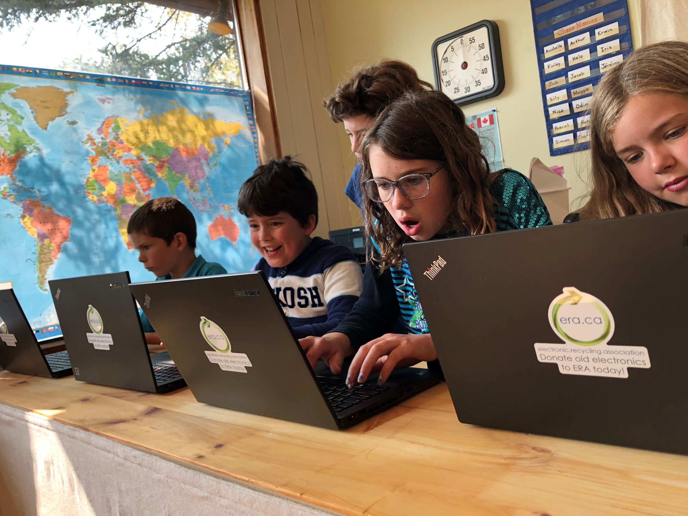 Students celebrating with donated ERA laptops