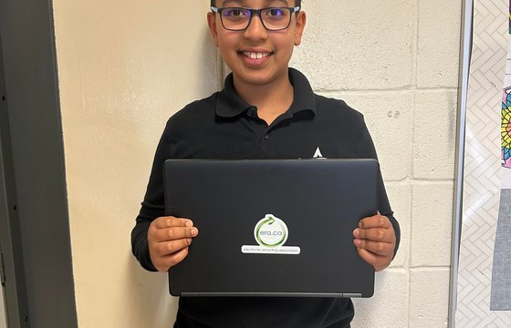 Scholarship recipient with refurbished laptop